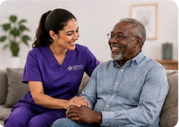 Armony caregiver sitting and laughing with a senior gentleman